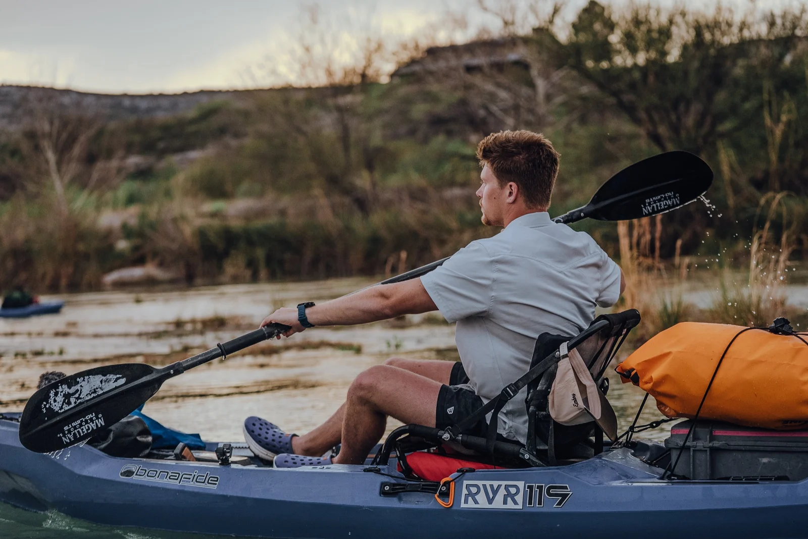 Luke Mayer operating a camera from a kayak on Devil’s River