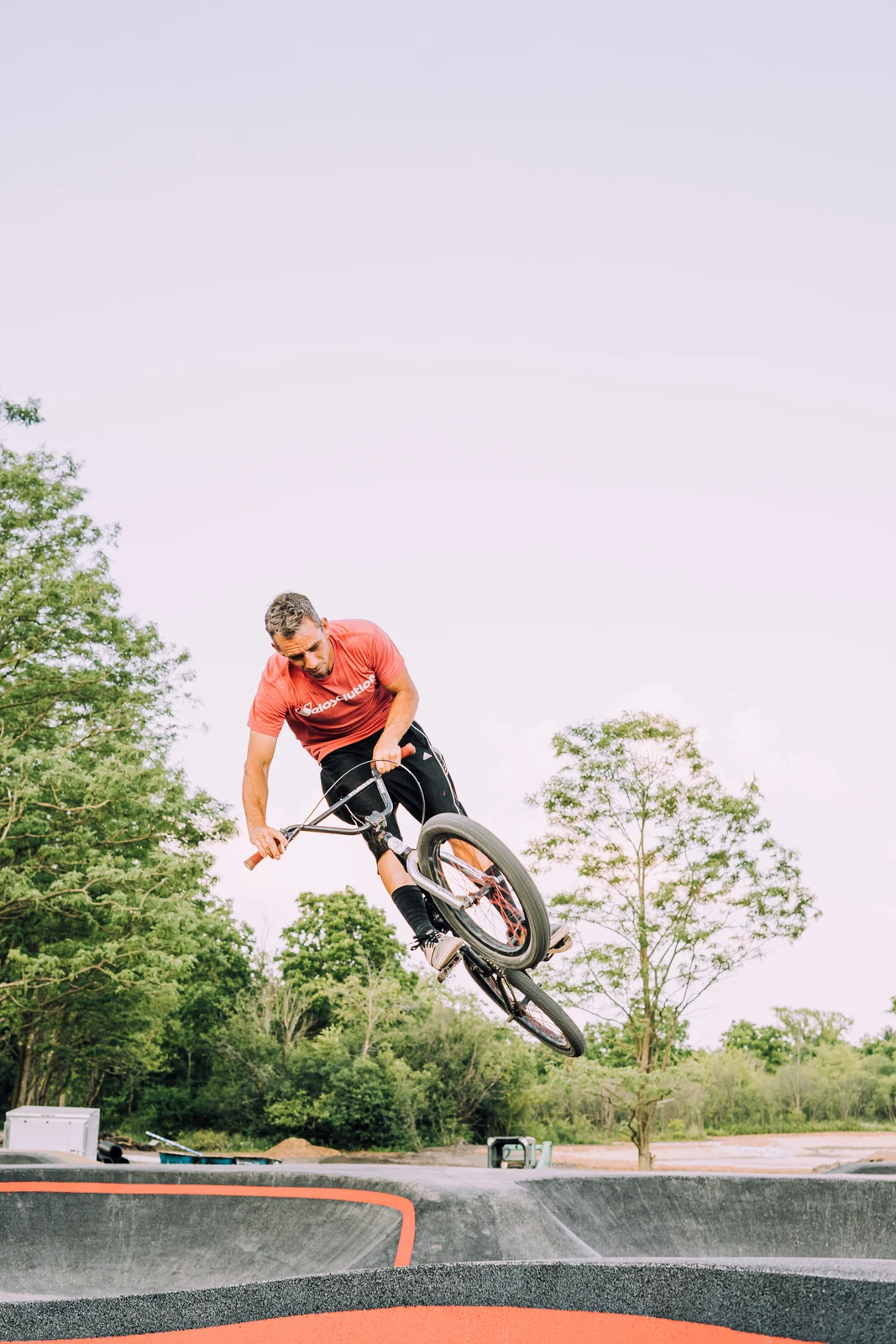 A BMX rider airborne at The Forge Lemont Quarries