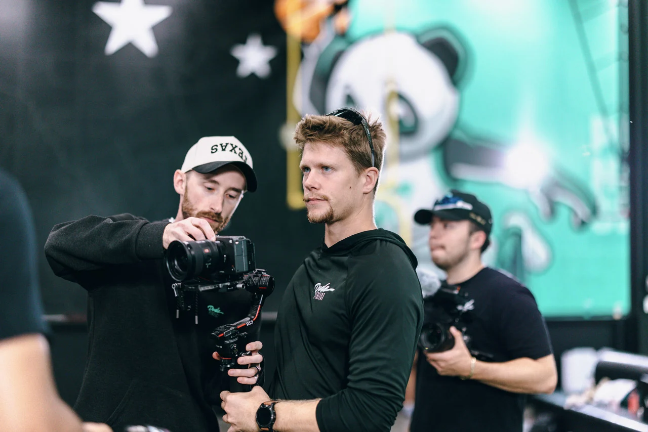 Luke Mayer balancing a camera on a gimbal during a studio shoot