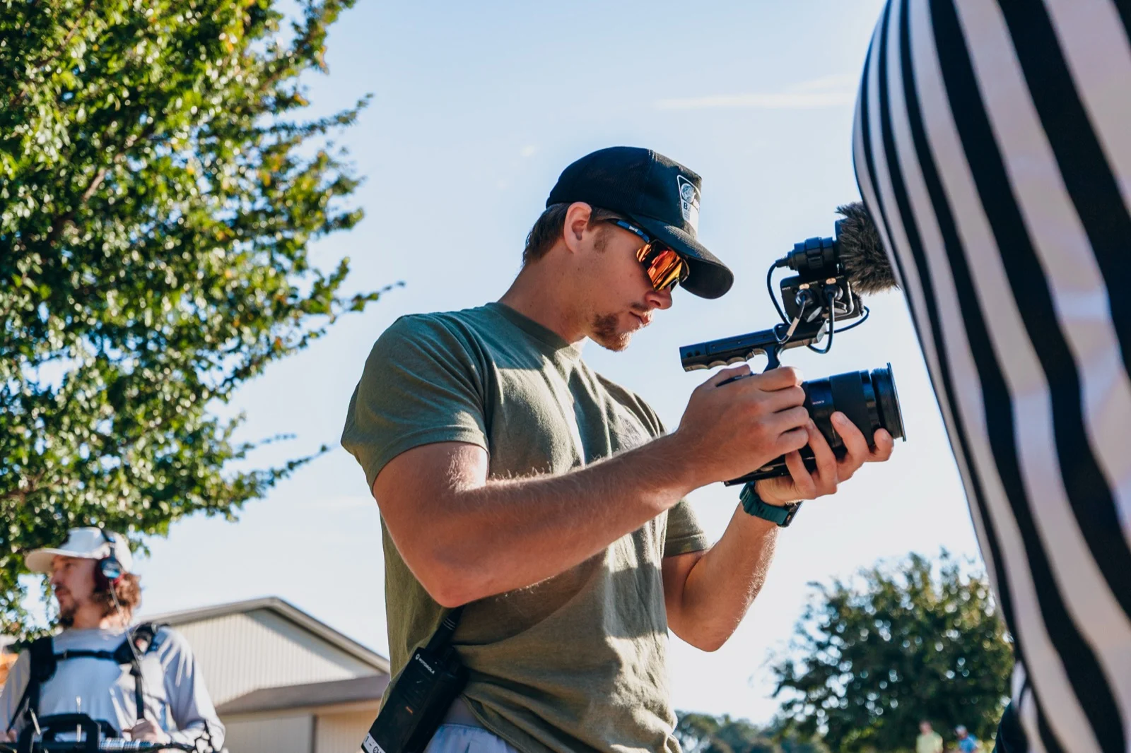 Luke Mayer operating a cinema camera on location